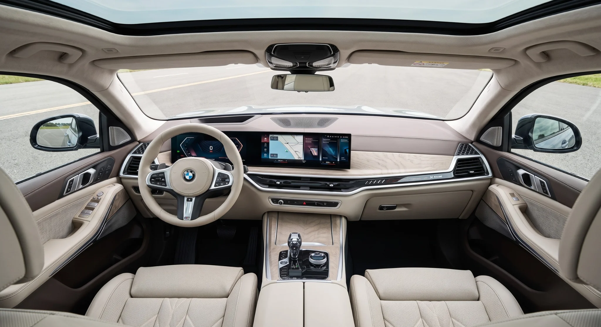Interior of the 2026 BMW X5 showing the BMW Curved Display, driver-focused dashboard, and Sensafin upholstery