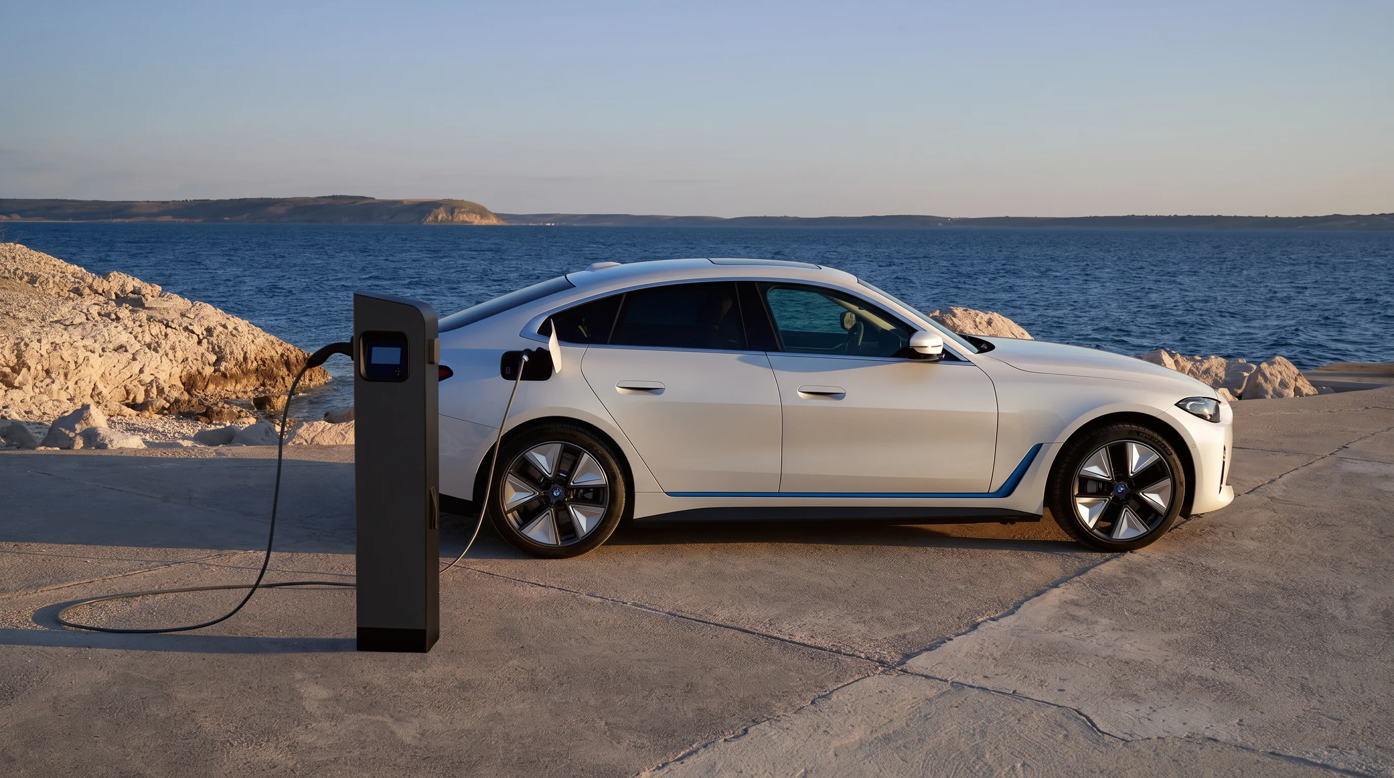 BMW electric vehicle plugged into a public EV charging station