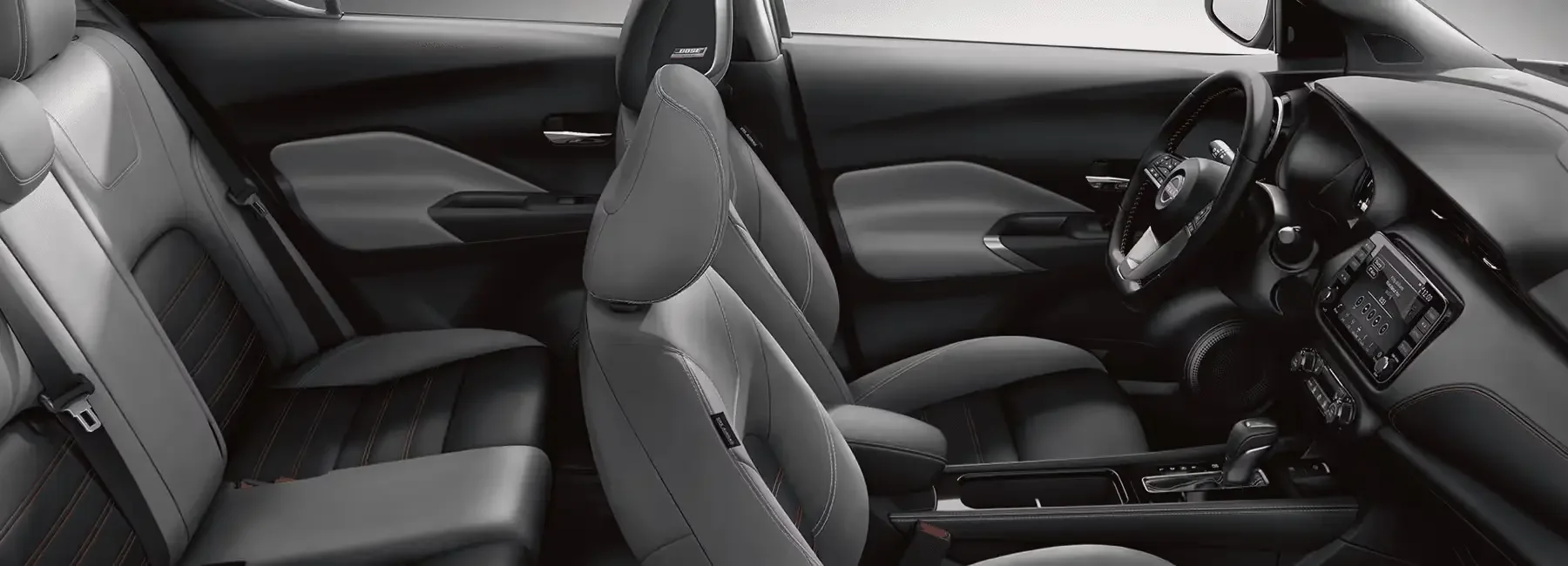 Front bucket seats and interior cabin view of a 2023 Nissan Kicks at Empire Nissan in Ontario, CA