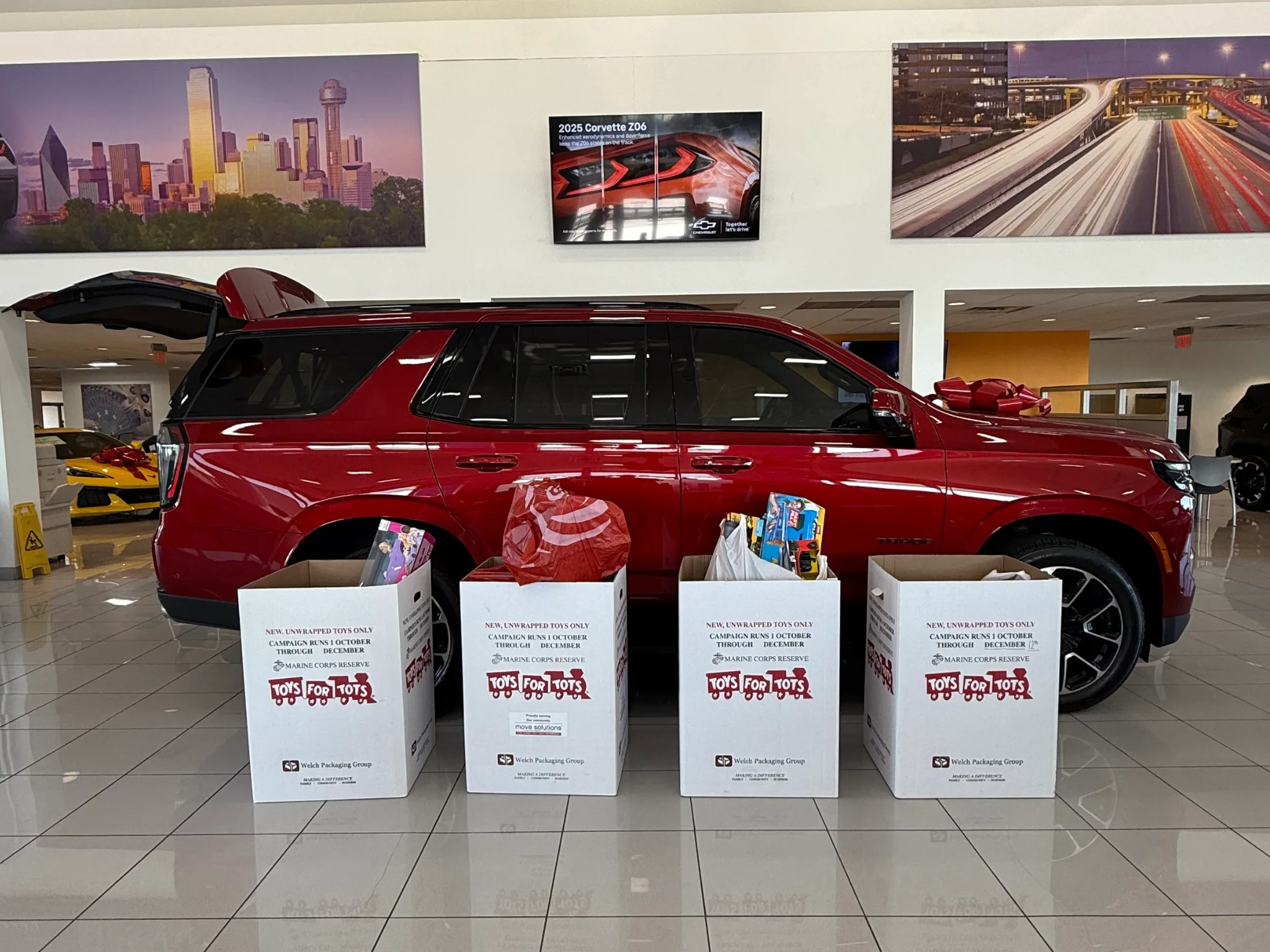 Galleria Chevrolet team with toys collected for the Toys for Tots drive in the showroom