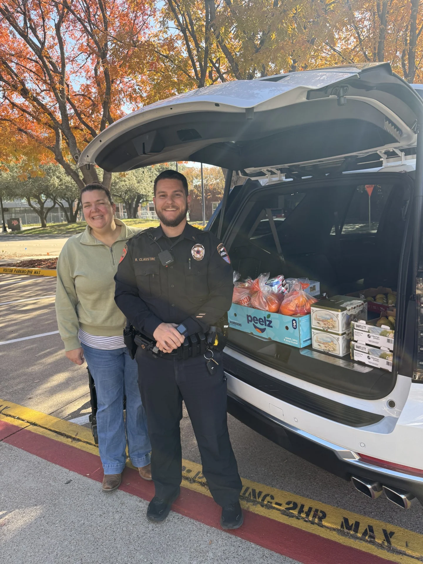 Addison Police Department officers receiving holiday deliveries from Galleria Chevrolet