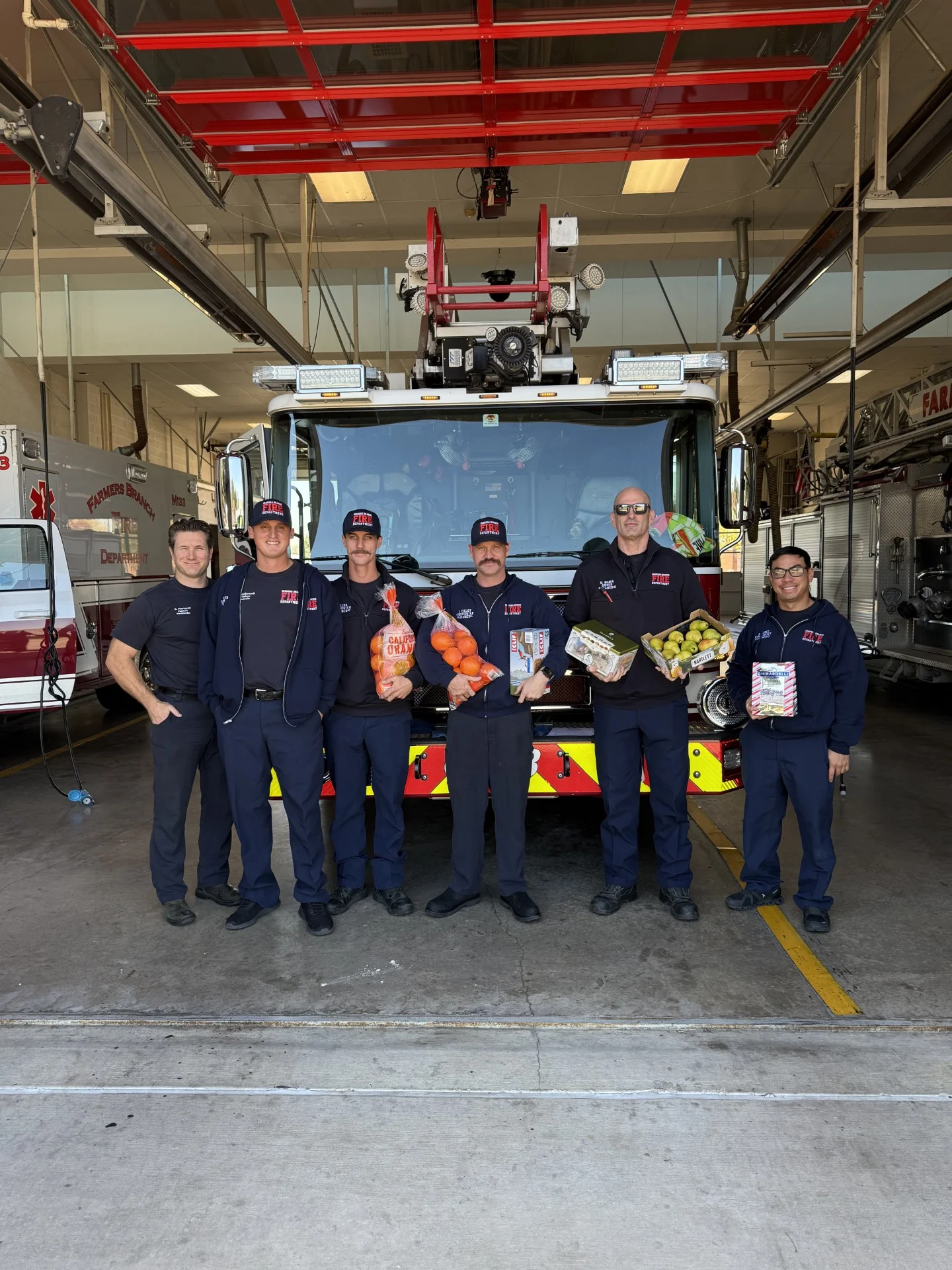 Farmers Branch Fire Department crew with holiday deliveries from Galleria Chevrolet