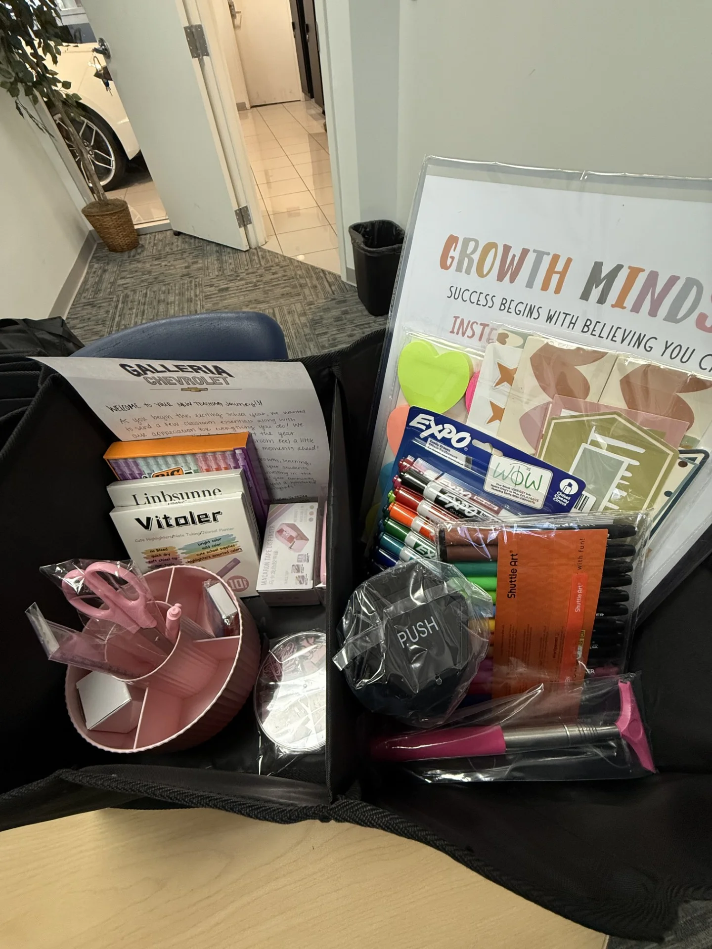 Trunk organizer and teacher supplies packed in the CFB ISD new hire welcome basket
