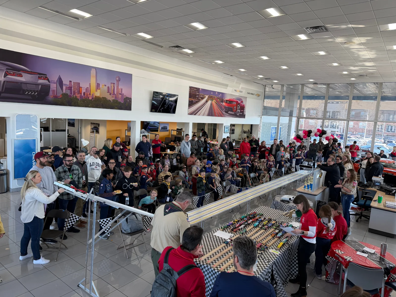 Cub Scouts Pack 806 Pinewood Derby race day on the Galleria Chevrolet showroom floor