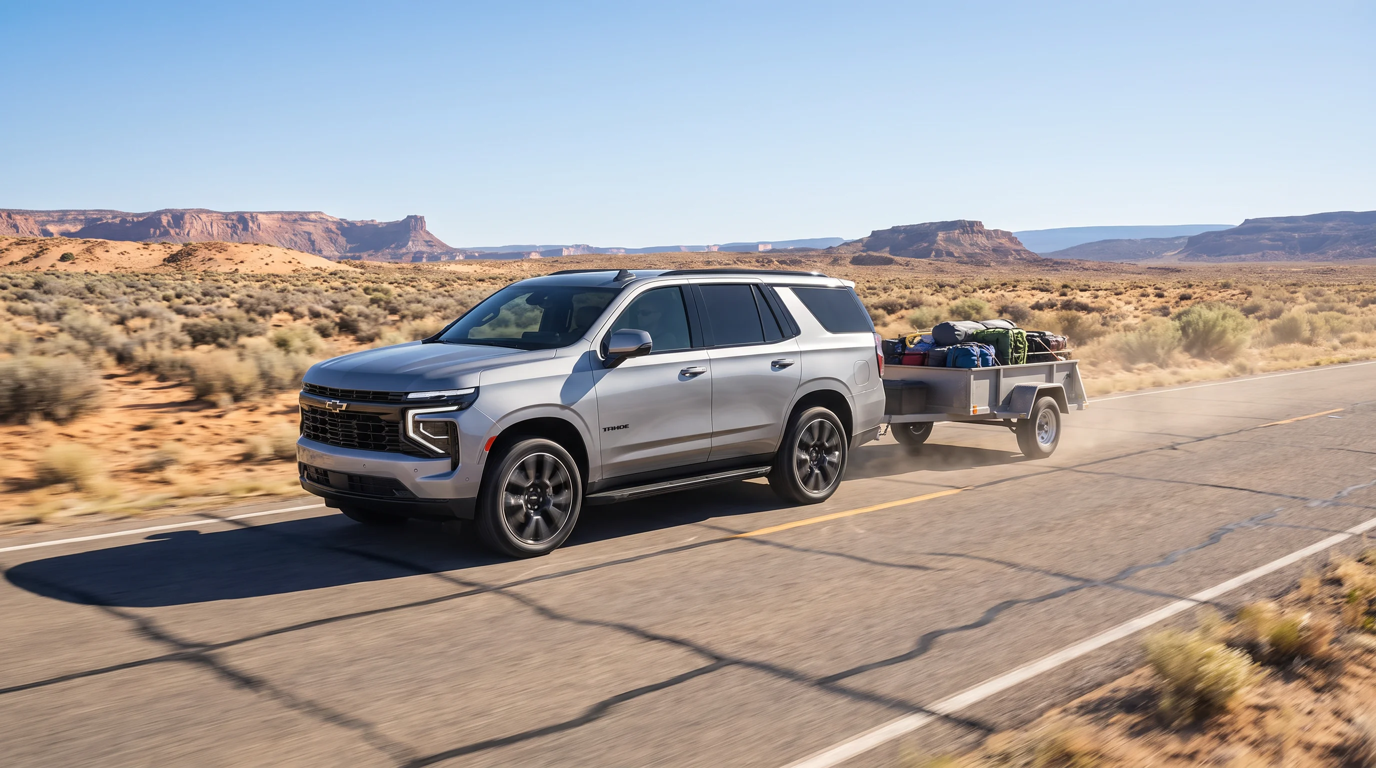 2026 Chevrolet Tahoe towing a trailer, showing the full-size SUV's trailering capability