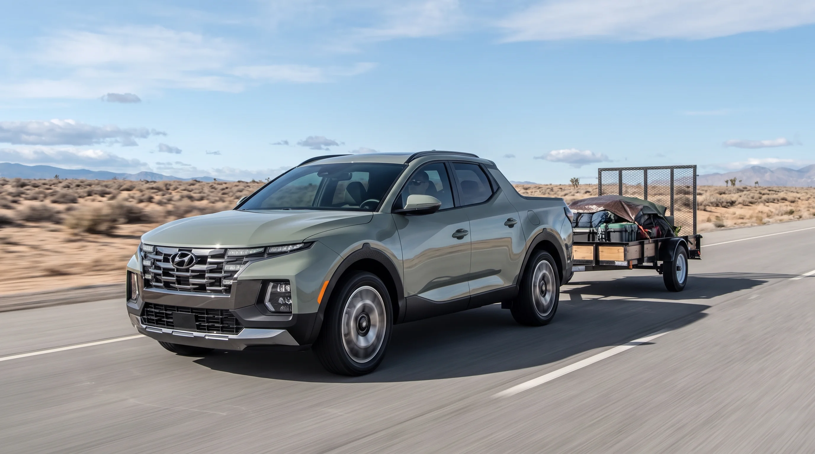 2026 Hyundai Santa Cruz towing a trailer, showing the pickup's 5,000-pound maximum towing capacity